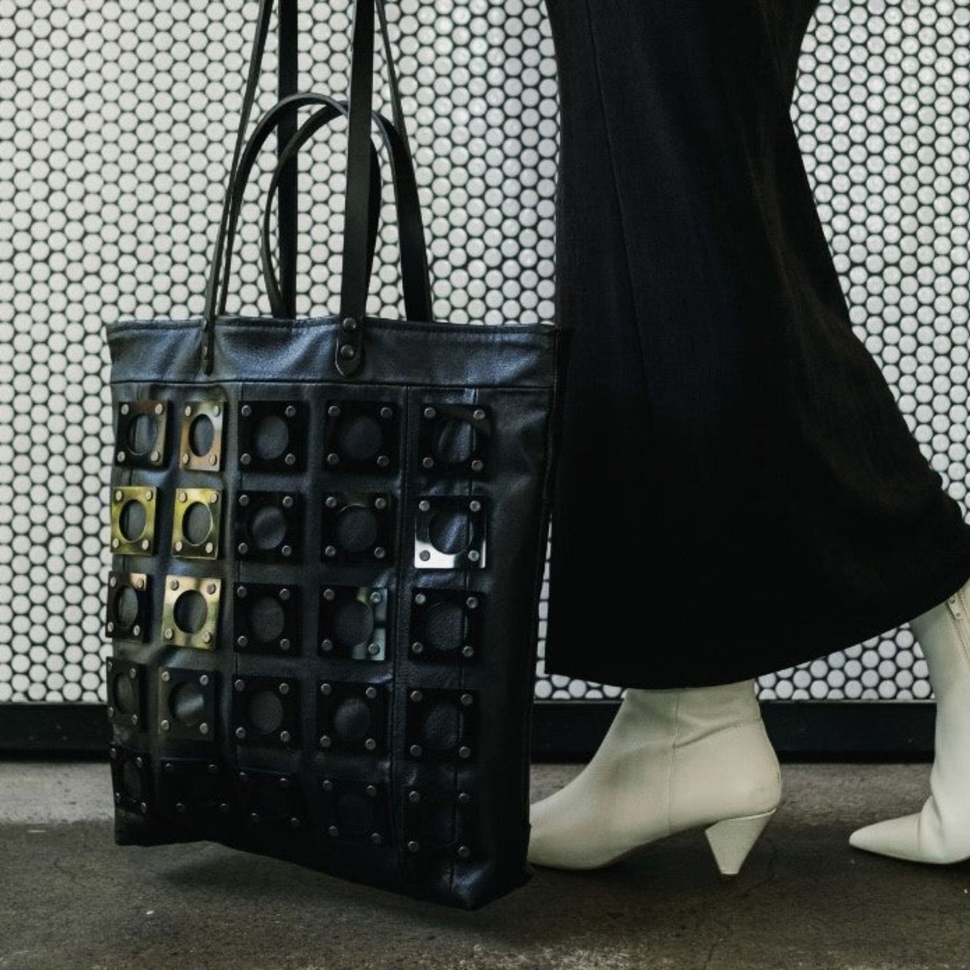 METANoIA black recycled leather tote handbag with square and hollowed circle bamboo and walnut acrylic forms fashioned into a repeative fashion.
