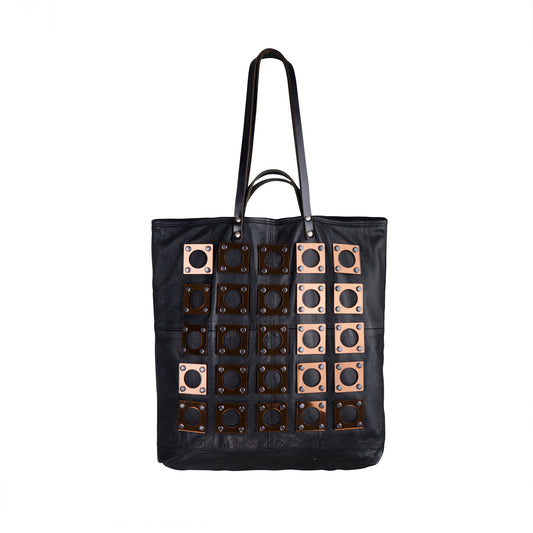METANoIA black recycled leather tote handbag with square and hollowed circle copper acrylic forms fashioned into a repeative fashion. 