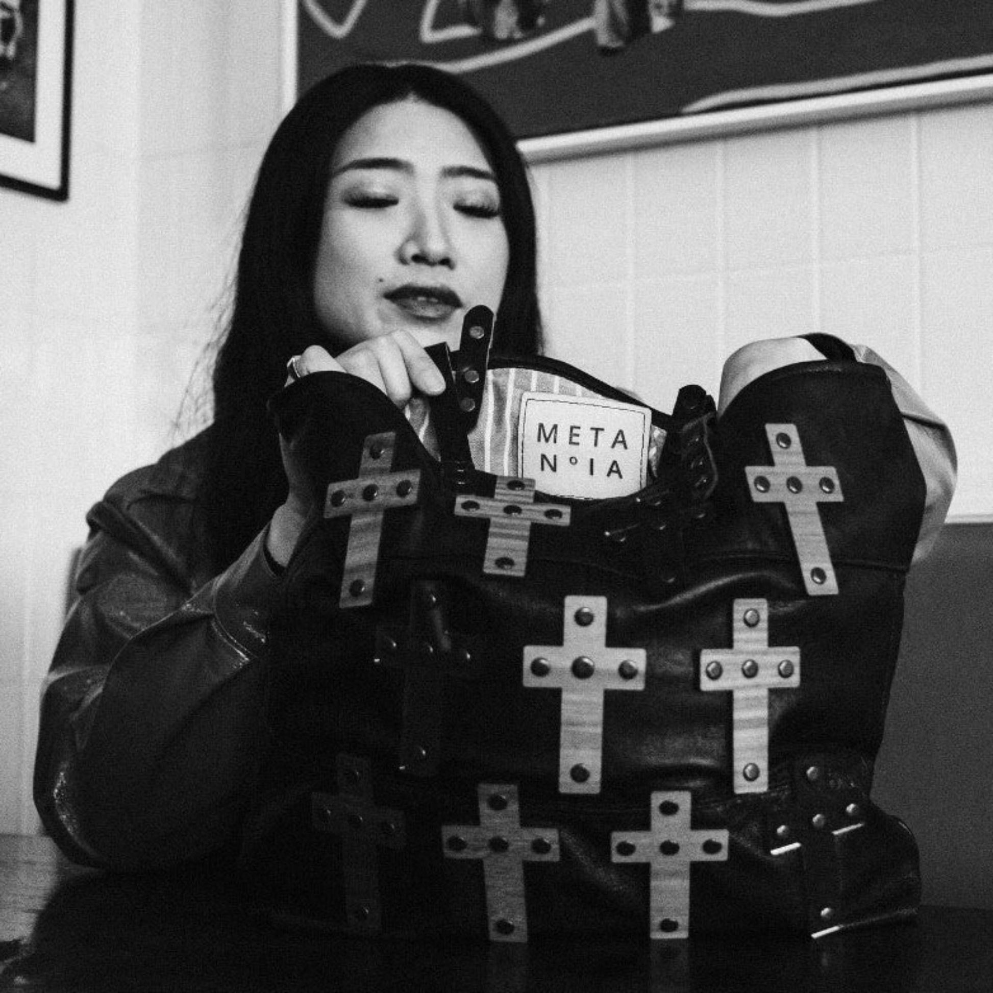 METANoIA The Cross Black recycled leather medium handbag with cross shaped bamboo, walnut and metallic acrylic forms.