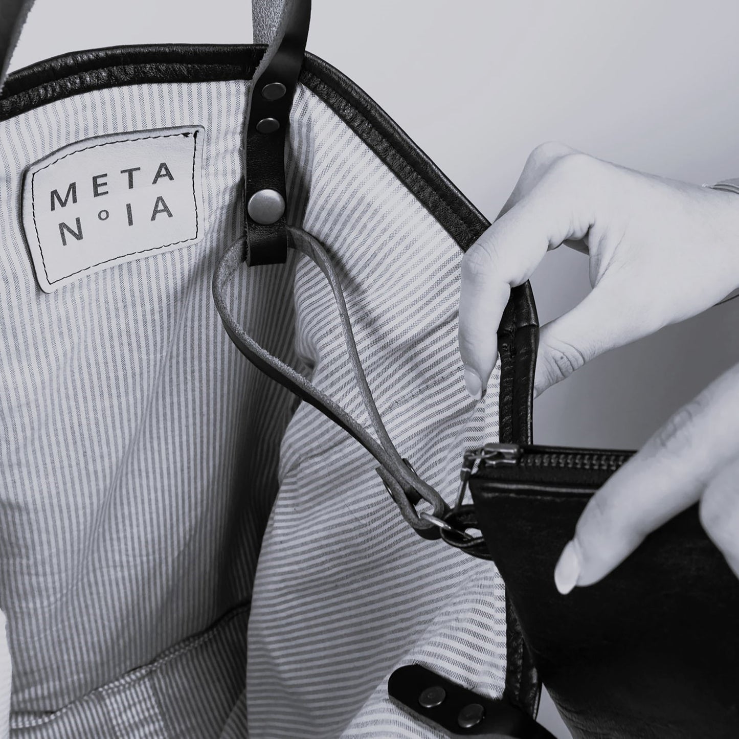 METANoIA The Disco Medium Bag inside featuring pinstripe fabric sourced from recycled fabric and a caramel leather woven label lasered with the iconic METANoIA label.
