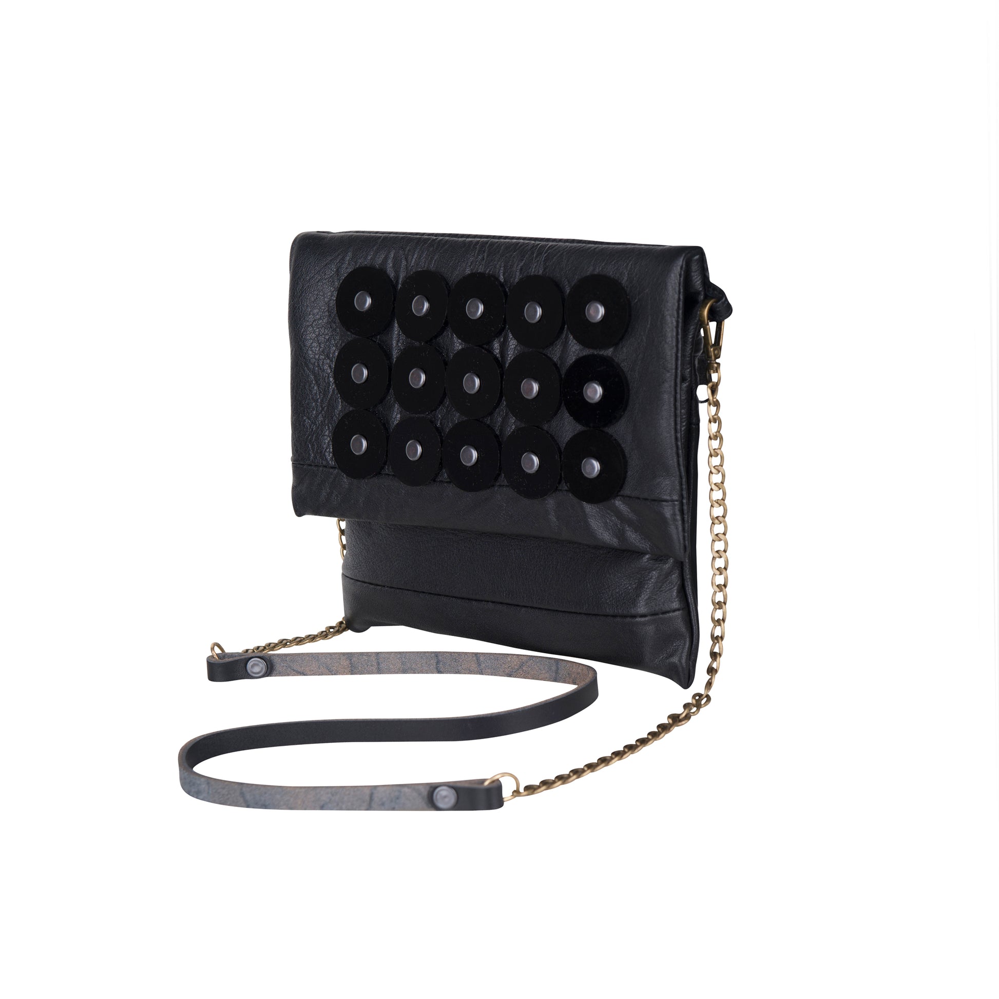 METANoIA black recycled leather small handbag with black circle acrylic forms fashioned into a repeative fashion with a smaller circle overlay on each form. 