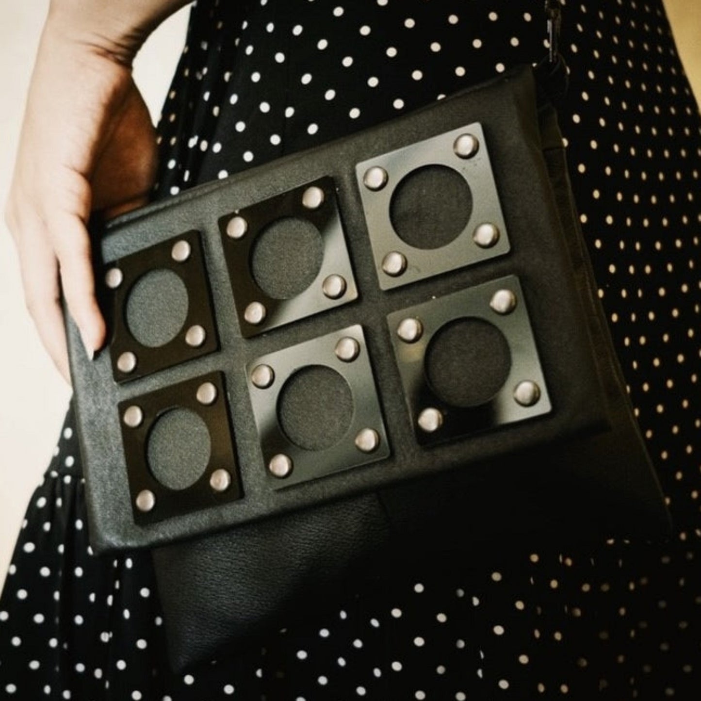 METANoIA black recycled leather small handbag with square and hollowed circle bamboo and walnut acrylic forms fashioned into a repetitive fashion. 